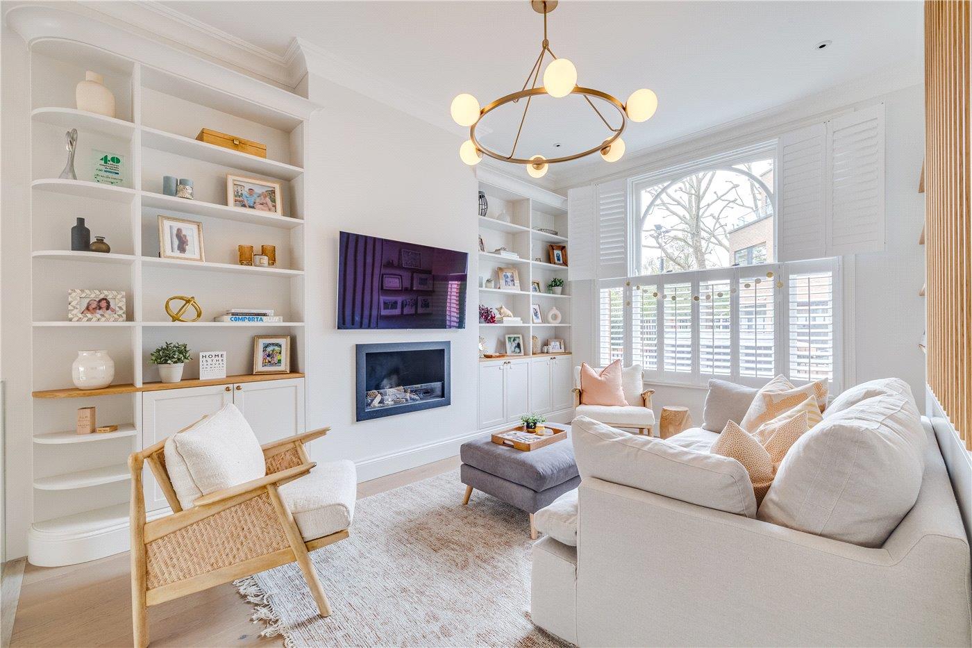 Bright reception room with built-in shelving and fireplace